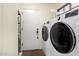 Functional laundry room with modern washer and dryer units, offering convenience and efficiency at 8737 E San Vicente Dr, Scottsdale, AZ 85258