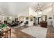Spacious living room with high ceilings, decorative chandelier, tile flooring, and ample natural light at 8737 E San Vicente Dr, Scottsdale, AZ 85258