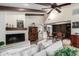 Bright living space with a fireplace, vaulted ceilings, exposed beams, and an open layout for entertaining at 8737 E San Vicente Dr, Scottsdale, AZ 85258