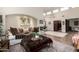 Comfortable living room showcasing a plush sofa, eye-catching art, and seamless transition to other areas at 8737 E San Vicente Dr, Scottsdale, AZ 85258