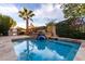 Sparkling swimming pool with a tranquil fountain and lush landscaping for privacy at 8737 E San Vicente Dr, Scottsdale, AZ 85258