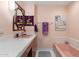Quaint bathroom with pink fixtures, tile floors, and a decorative mirror at 945 W 10Th St, Mesa, AZ 85201