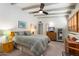 Relaxing bedroom featuring neutral tones, beamed ceiling, and functional work space at 945 W 10Th St, Mesa, AZ 85201
