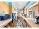 A lovely kitchen with wood cabinetry, stainless appliances, and a colorful runner rug at 945 W 10Th St, Mesa, AZ 85201