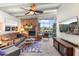 Spacious living room featuring a brick fireplace, large windows, and stylish decor with ceiling fan at 945 W 10Th St, Mesa, AZ 85201