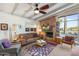 Cozy living room with brick fireplace and a large window that fills the space with natural light at 945 W 10Th St, Mesa, AZ 85201