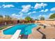 Sparkling pool with diving board is surrounded by desert landscaping for outdoor enjoyment at 945 W 10Th St, Mesa, AZ 85201