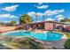 Backyard pool with rock feature and patio offers a refreshing oasis for relaxation and outdoor enjoyment at 945 W 10Th St, Mesa, AZ 85201