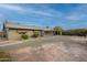 Backyard view showing the home's covered patio, and gravel area perfect for customization and outdoor enjoyment at 10018 N 103Rd Ave, Sun City, AZ 85351