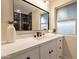 Bathroom vanity with decorative mirror, white countertop, and modern fixtures at 10018 N 103Rd Ave, Sun City, AZ 85351