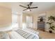 Relaxing bedroom with neutral tones, ceiling fan, and decorative plants at 10018 N 103Rd Ave, Sun City, AZ 85351