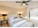 Cozy bedroom featuring a ceiling fan, soft lighting, and elegant decor at 10018 N 103Rd Ave, Sun City, AZ 85351