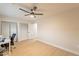 Neutral bedroom with laminate floors, a ceiling fan, and double closets for ample storage at 10018 N 103Rd Ave, Sun City, AZ 85351