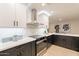 Modern kitchen featuring stainless steel appliances, sleek cabinetry, and elegant countertops at 10018 N 103Rd Ave, Sun City, AZ 85351