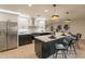 Beautiful kitchen island with stainless steel appliances and white cabinetry offers a modern look at 10018 N 103Rd Ave, Sun City, AZ 85351