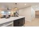 Stylish kitchen island in an open-concept layout, showcasing modern design and seamless connectivity with living space at 10018 N 103Rd Ave, Sun City, AZ 85351