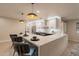 Stunning kitchen island with a waterfall countertop, modern pendants, and bar seating, great for entertaining at 10018 N 103Rd Ave, Sun City, AZ 85351