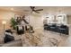 Inviting living room and kitchen featuring modern design, hardwood floors, and stainless steel appliances at 10018 N 103Rd Ave, Sun City, AZ 85351