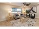 Bright living room with stylish furniture, hardwood floors, and a large window for ample natural light at 10018 N 103Rd Ave, Sun City, AZ 85351