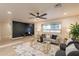 Well-lit living room boasting elegant decor, hardwood floors, and a comfortable seating area at 10018 N 103Rd Ave, Sun City, AZ 85351