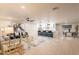 Bright, open-concept living room featuring modern furnishings and a seamless flow to the kitchen and dining area at 10018 N 103Rd Ave, Sun City, AZ 85351