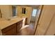 Bathroom features dual sinks, vanity with wood-look cabinets, and well-lit mirror, creating a serene atmosphere at 10039 W Kingman St, Tolleson, AZ 85353