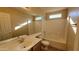 Bathroom with a large mirror, vanity, and shower-tub combo at 10039 W Kingman St, Tolleson, AZ 85353