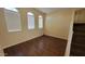 A bright bedroom with laminate floors featuring large windows that provide natural light at 10039 W Kingman St, Tolleson, AZ 85353