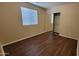 A cozy bedroom with laminate floors and a mirrored closet door for space-saving and style at 10039 W Kingman St, Tolleson, AZ 85353