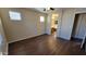 Bedroom with hardwood flooring, ceiling fan, and view into the ensuite bathroom at 10039 W Kingman St, Tolleson, AZ 85353