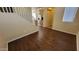 Bright living area with wood-look floors, staircase, and natural light, creating a warm and inviting space at 10039 W Kingman St, Tolleson, AZ 85353