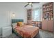 Cozy bedroom featuring built-in shelving, a comfortable bed, soft carpet, a modern ceiling fan and a bedside lamp at 1232 E Silver Reef Dr, Casa Grande, AZ 85122