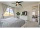 Bright main bedroom featuring soft carpet, tree, and a large TV at 1232 E Silver Reef Dr, Casa Grande, AZ 85122