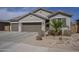 Attractive one-story home showcasing a three-car garage, neutral stucco facade, xeriscaped front yard, and a clay tile roof at 1232 E Silver Reef Dr, Casa Grande, AZ 85122