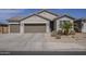 Charming single-story home featuring a three-car garage, neutral stucco facade, desert landscaping, and a tile roof at 1232 E Silver Reef Dr, Casa Grande, AZ 85122