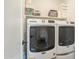 Well-lit laundry room featuring a Maytag washer and dryer on a white shelf at 1232 E Silver Reef Dr, Casa Grande, AZ 85122