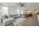 Bright living room featuring a large gray sectional, wood floors, and an open concept design to the kitchen at 1232 E Silver Reef Dr, Casa Grande, AZ 85122