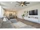 A cozy living room featuring wood floors, a large sectional, and a built-in media center at 1232 E Silver Reef Dr, Casa Grande, AZ 85122