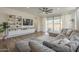 Relaxing living room leading to the backyard pool, featuring a large sectional and wood floors at 1232 E Silver Reef Dr, Casa Grande, AZ 85122