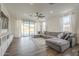 Cozy living room with a large gray sectional, wood floors, and a bright atmosphere at 1232 E Silver Reef Dr, Casa Grande, AZ 85122