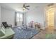 A bright play room featuring wood floors, a ceiling fan, and a large window at 1232 E Silver Reef Dr, Casa Grande, AZ 85122