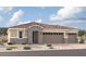 Inviting single-story home boasting a neutral color palette, a three-car garage, and a tiled roof at 12365 W Marguerite Ave, Avondale, AZ 85323