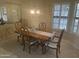 Elegant dining room with a chandelier, a wooden table with seating for six, and natural light at 13034 W Peach Blossom Dr, Sun City West, AZ 85375