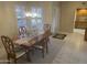 Well-lit dining area with a classic wooden table and modern lighting at 13034 W Peach Blossom Dr, Sun City West, AZ 85375