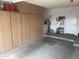 Garage featuring built in storage cabinets and work area to keep your belongings organized at 13034 W Peach Blossom Dr, Sun City West, AZ 85375