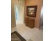 Neutral hallway with elegant tile flooring and decorative cabinet at 13034 W Peach Blossom Dr, Sun City West, AZ 85375