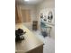 Kitchen featuring an espresso maker, neutral counter tops, and modern white tile flooring at 13034 W Peach Blossom Dr, Sun City West, AZ 85375