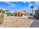 Landscaped backyard featuring mature trees, a covered patio, and low-maintenance desert terrain at 13764 W Meeker Blvd, Sun City West, AZ 85375