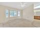 Bright bedroom with a ceiling fan, bay windows with shutters and an attached bathroom at 13764 W Meeker Blvd, Sun City West, AZ 85375