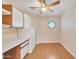 Bright breakfast nook featuring wood floors, decorative windows, and white kitchen storage at 13764 W Meeker Blvd, Sun City West, AZ 85375